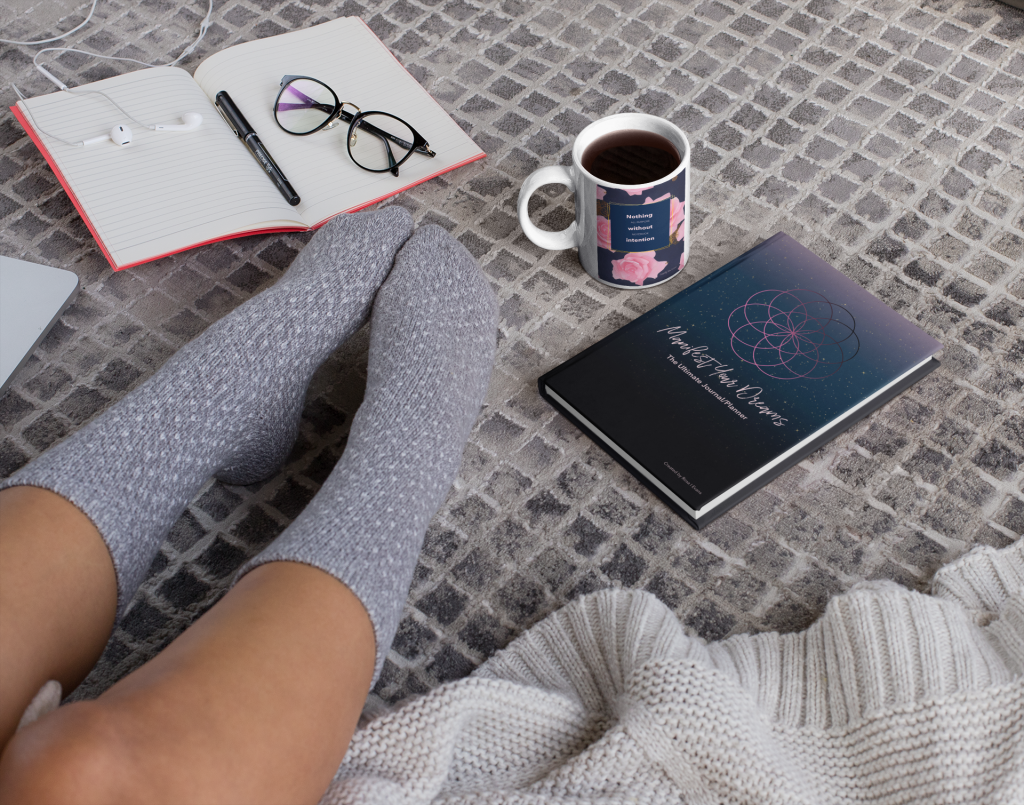 Cozy reading nook with an inspirational manifestation journal, a warm cup of coffee, and glasses, inviting personal growth and reflection.